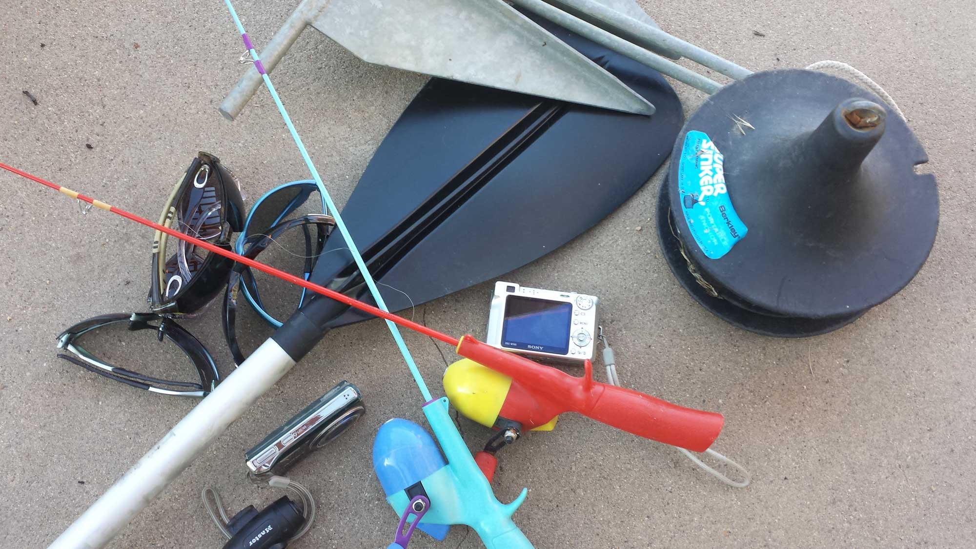 lost and found items - camera, fishing pole, oar, anchor