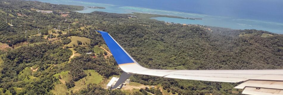 airplane wing over an island
