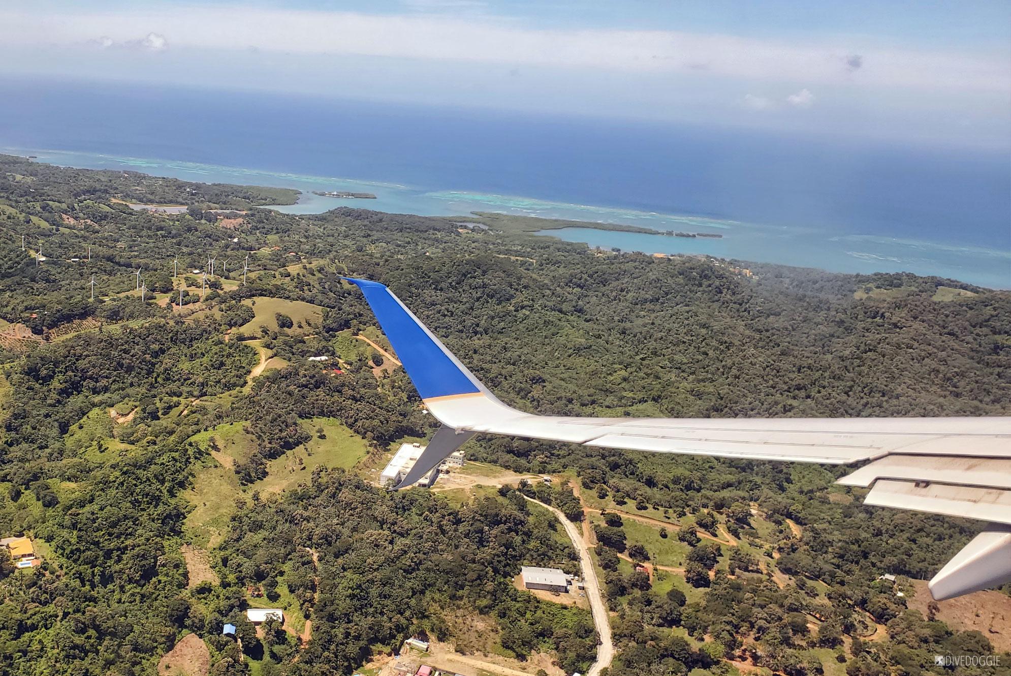 airplane wing over an island